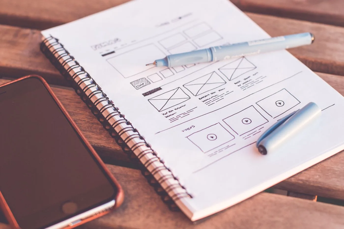 Custom web design workspace showing website layouts on a laptop